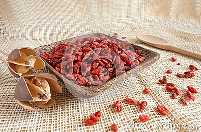 Red goji beans in a wooden cup - country style Stock Photo