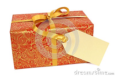 Red and gold Christmas gift with gift tag label isolated on white background Stock Photo