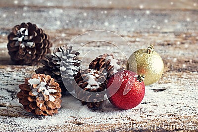 Red and gold christmas ornament pine cones on wooden Stock Photo