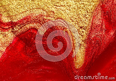 Red and gold nail polish fluid texture. Stock Photo