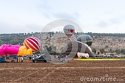 Red - gray hot air balloon flies up from the ground at the hot air balloon festival Editorial Stock Photo