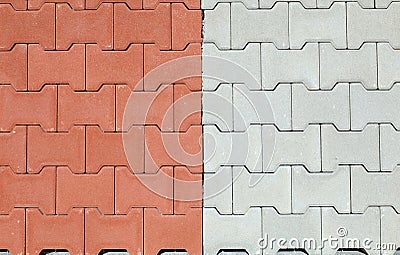 Red and gray interlocking concrete paver blocks. Tiles for outdoor pavement. Samples. Stock Photo