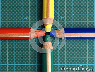 RGBY red, green, blue and yellow colored pencils on a cutting mat Stock Photo