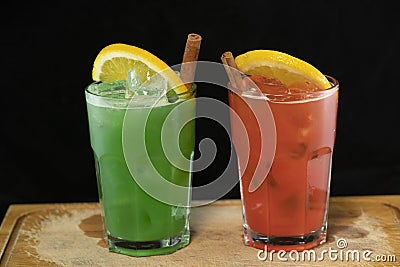 Red and Green Cocktails with red and green juices, alcohol and lime wedge Stock Photo