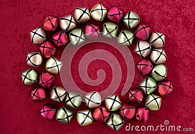 Red, green, gold, and silver in a round framed shape on a red velvet background Stock Photo