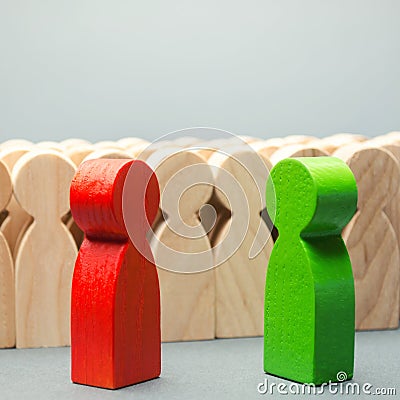 Red and green people stand in front of a crowd. Two opponents. Conflict of interest. Dispute. Search for compromises. Social Stock Photo