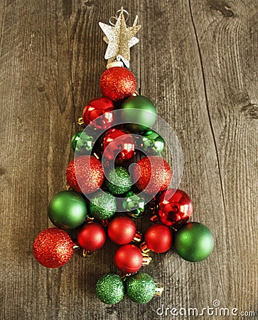 Red and green sparkly Christmas balls, decorations to form tree with white star Stock Photo