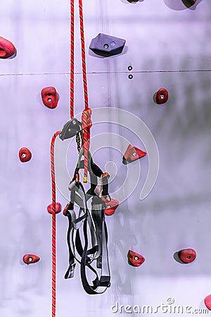 Red and grey rock climbing wall with carabiner hook and climbing Stock Photo