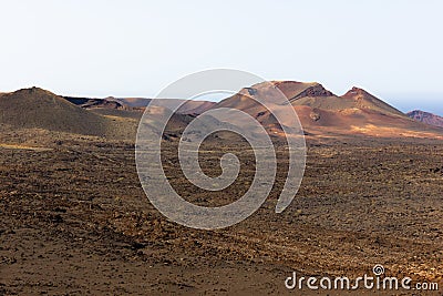 Red ground volcanos in Timanfaya National Park Stock Photo