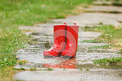 Red gumboots in rain Stock Photo