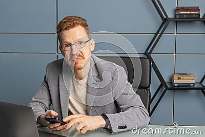 red-haired man with glasses in the office Stock Photo