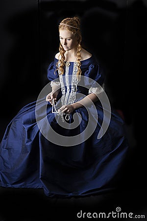 Renaissance century woman in a blue silk gown Stock Photo