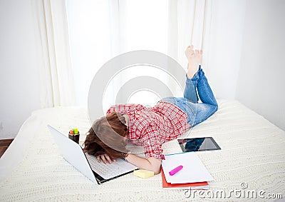 Red haired student alseep on laptop while studing Stock Photo