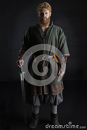 Red-haired Viking posing with weapons Stock Photo