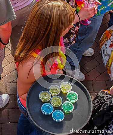 A Red haired waitress carries tray of jellow shots - top view Kansas City MO USA May 5 2011 Editorial Stock Photo