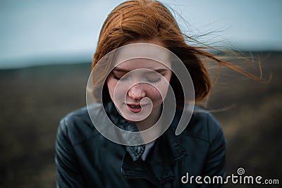 The red-haired woman tilted her head and closed her eyes. Stock Photo