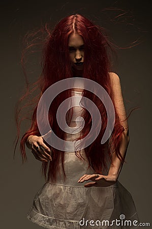 Red haired zombie woman in white cotton dress Stock Photo