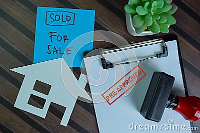 Red Handle Rubber Stamper Pre-Approved and Sold For Sale text isolated on wooden table Stock Photo