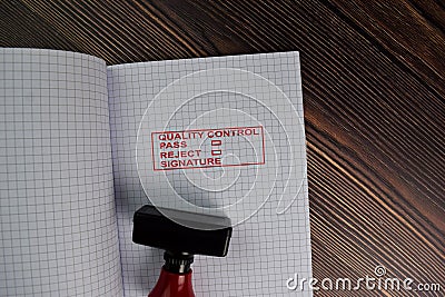 Red Handle Rubber Stamper and Quality Control, Pass, Reject and Signature text isolated on the table Stock Photo