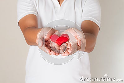 red heart in asian man hands,health- medicine and charity concept Stock Photo