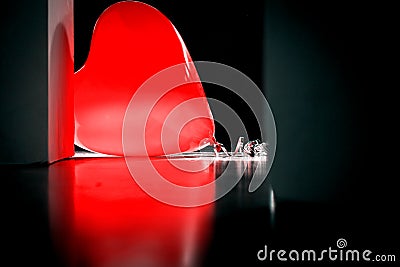 Red heart balloon laid on ceramic tiles floor. Stock Photo