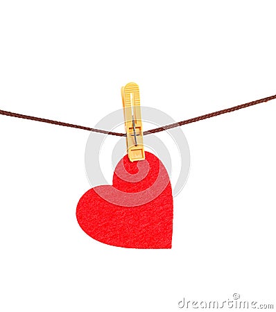 Red heart from dense fabric on a clothespeg on a rope Stock Photo