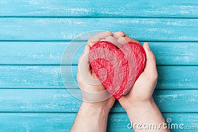 Red heart in hands top view. Healthy, love, donation organ, donor, hope and cardiology concept. Valentines day card. Stock Photo