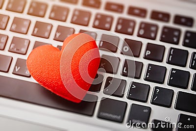 Red heart on laptop keyboard flirt love chat or lover online text messenger for meeting date Stock Photo