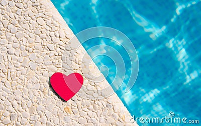 A red heart lies on the edge of the pool. Good summer holiday concept Stock Photo