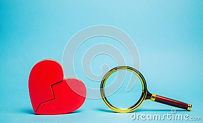 Red heart and a magnifying glass. The concept of finding love and relationships. Find a soul mate. Loneliness. Family psychologist Stock Photo