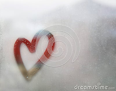 Red heart outline painted on sweaty glass, there are many drops on it, inscription heart and love handmade on wet autumn foggy Stock Photo