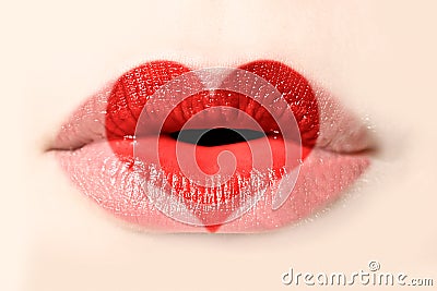 Red heart painted on woman lips close up Stock Photo