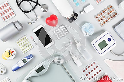 Red heart with phonendoscope scale tablets. Medical flat lay Stock Photo