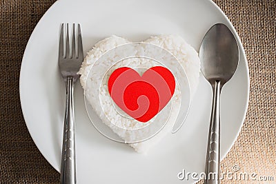 Red heart on rice heart shape on whiteplate Stock Photo