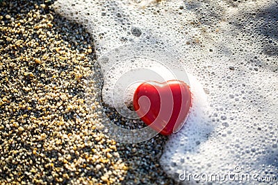 Red heart by the sea, romantic, in love, lost, holiday Stock Photo