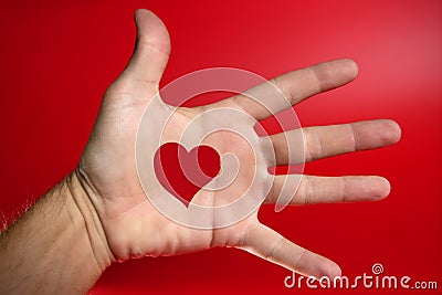 Red heart shape drawed on a male human hand Stock Photo