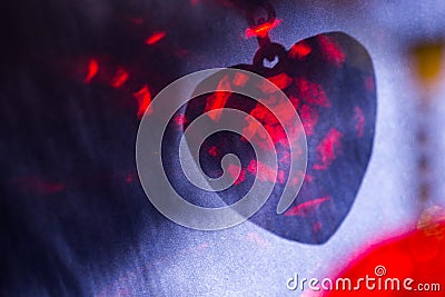 Red heart shape shadow on blue surface, abstract holiday background Stock Photo