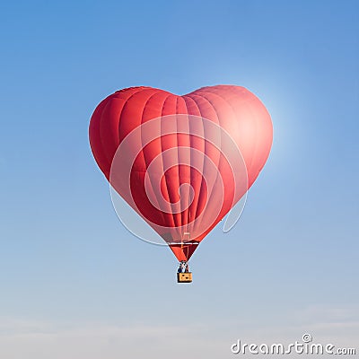 Red heart shaped air ballon isolated in the sky Stock Photo