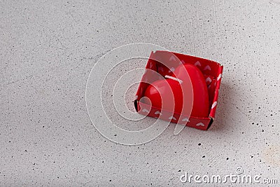 Red heart-shaped candle in box on white background. Small Valentines day present, symbol or souvenir. Copy space Stock Photo