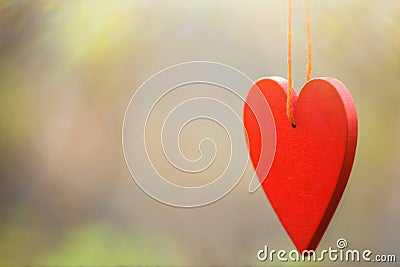 Red heart on a string on a beautiful blurred background. Stock Photo