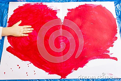 Red Heart Symbol - Hand Made with Child Hand Stock Photo