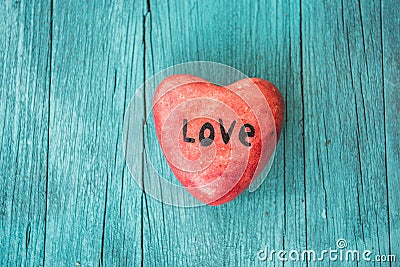 Red heart and turquoise wooden background in country style. Stock Photo