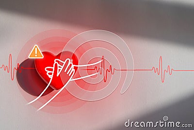 Red heart on a white paper, a symbol showing heart disease patients with recurrent high blood pressure disease Stock Photo