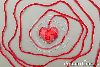 Red heart wrapped around with rope Stock Photo