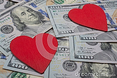 Red hearts on a background of dollar banknotes. Money love Stock Photo
