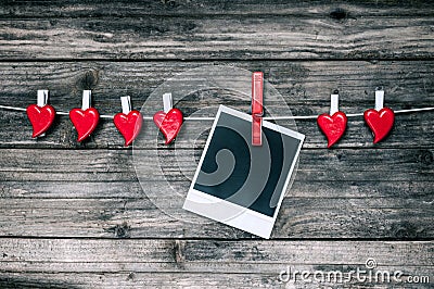 Red hearts and blank photo instant on grunge wooden background. Stock Photo