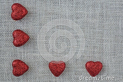 Red Hearts on Burlap Background Stock Photo