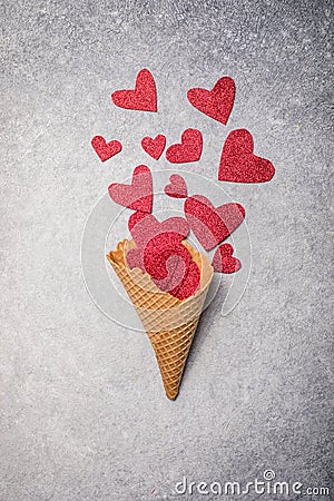 Red hearts pouring in waffle horn. Valentines love, date concept with copy space, flat lay Stock Photo