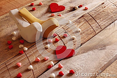 Red hearts and two loving birds on wooden table Stock Photo