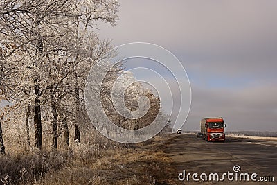 Red heavy vehicles on the winter road Editorial Stock Photo